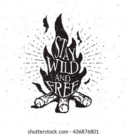 Hand drawn campfire typography badge. Stay wild and free quote. Outdoor camping themed print for t-shirt, vector