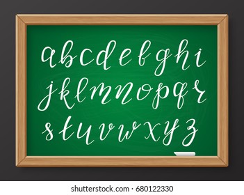 Hand drawn chalk calligraphic lowercase letters of the Latin alphabet on green realistic chalkboard