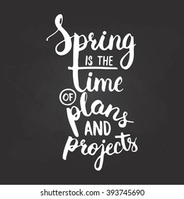 Hand drawn chalk typography lettering phrase Spring is the time of plans and projects on the black chalkboard background. Modern calligraphy for typography greeting invitation card or t-shirt print.