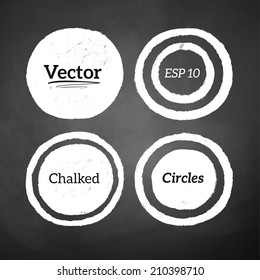 Hand drawn chalked circles and rings on blackboard background. Vector set