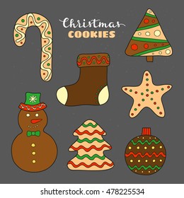 Hand drawn Christmas cookies with icing and decor isolated on chalkboard background.