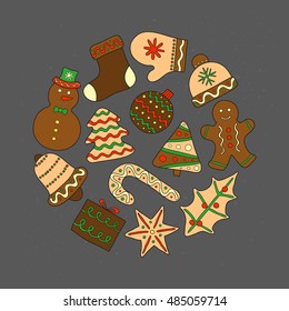 Hand drawn Christmas cookies with icing composed in circle shape on chalkboard background.