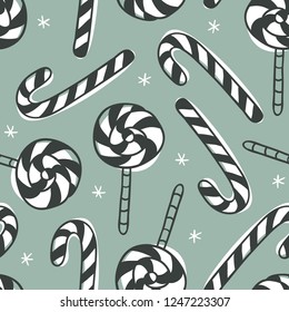 Hand drawn Christmas seamless pattern with candy on green background. Creative ink art work. Actual vector doodle drawing sweets