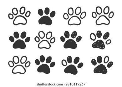 Hand drawn collection of various dog and cat paw prints featuring solid black shapes and outlined doodle style ink sketches