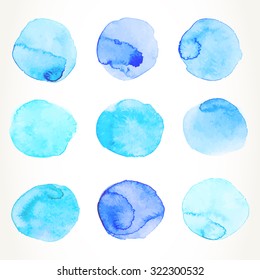 Hand drawn colorful light blue watercolor circles, isolated over white.
