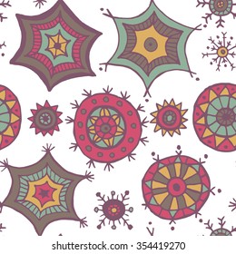 Hand drawn colorful snowflakes doodles arranged in a seamless pattern. Tribal circular patterns. Abstract round design elements.