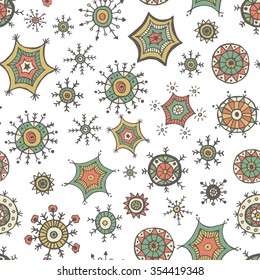 Hand drawn colorful snowflakes doodles arranged in a seamless pattern. Tribal circular patterns. Abstract round design elements.