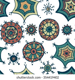 Hand drawn colorful snowflakes doodles arranged in a seamless pattern. Tribal circular patterns. Abstract round design elements.