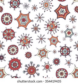 Hand drawn colorful snowflakes doodles arranged in a seamless pattern. Tribal circular patterns. Abstract round design elements.