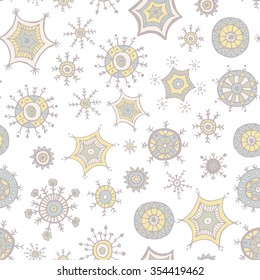 Hand drawn colorful snowflakes doodles arranged in a seamless pattern. Tribal circular patterns. Abstract round design elements.