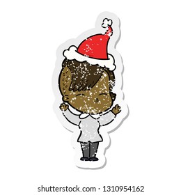 hand drawn distressed sticker cartoon of a squinting girl wearing santa hat