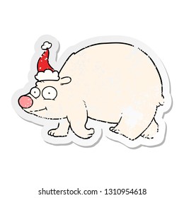 hand drawn distressed sticker cartoon of a walking polar bear wearing santa hat