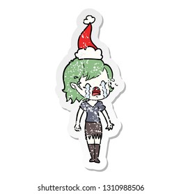 hand drawn distressed sticker cartoon of a crying vampire girl wearing santa hat
