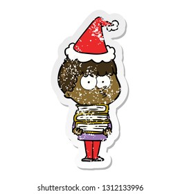 hand drawn distressed sticker cartoon of a curious boy with lots of books wearing santa hat