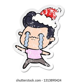 hand drawn distressed sticker cartoon of a man crying wearing santa hat