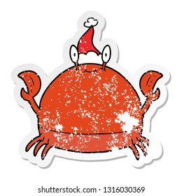 hand drawn distressed sticker cartoon of a crab wearing santa hat