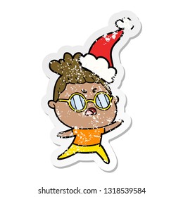 hand drawn distressed sticker cartoon of a annoyed woman wearing santa hat