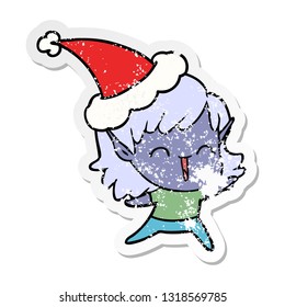 hand drawn distressed sticker cartoon of a elf girl wearing santa hat
