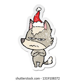 hand drawn distressed sticker cartoon of a annoyed wolf wearing santa hat