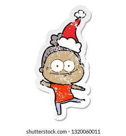 hand drawn distressed sticker cartoon of a happy old woman wearing santa hat