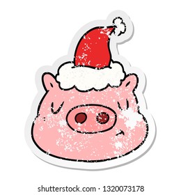 hand drawn distressed sticker cartoon of a pig face wearing santa hat