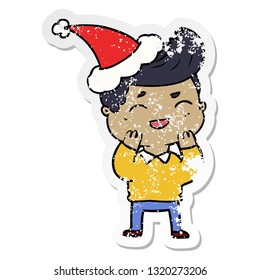 hand drawn distressed sticker cartoon of a man laughing wearing santa hat