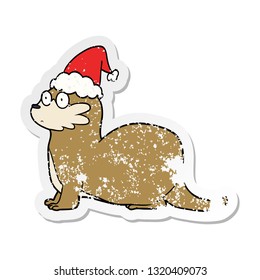 hand drawn distressed sticker cartoon of a otter wearing santa hat