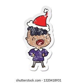 hand drawn distressed sticker cartoon of a happy boy laughing wearing santa hat