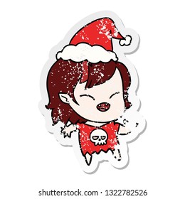 hand drawn distressed sticker cartoon of a laughing vampire girl wearing santa hat