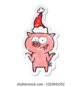 hand drawn distressed sticker cartoon of a pig with no worries wearing santa hat