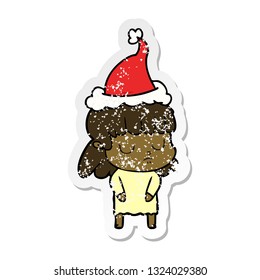 hand drawn distressed sticker cartoon of a indifferent woman wearing santa hat