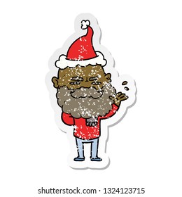 hand drawn distressed sticker cartoon of a dismissive man with beard frowning wearing santa hat