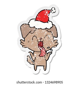 hand drawn distressed sticker cartoon of a panting dog shrugging shoulders wearing santa hat