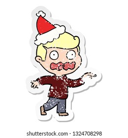 hand drawn distressed sticker cartoon of a stressed out pointing wearing santa hat