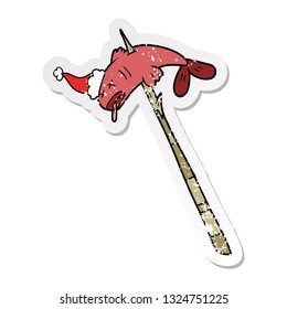 hand drawn distressed sticker cartoon of a fish speared wearing santa hat