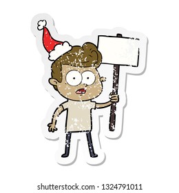 hand drawn distressed sticker cartoon of a staring man wearing santa hat