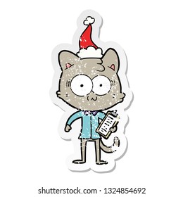 hand drawn distressed sticker cartoon of a surprised office worker cat wearing santa hat