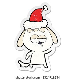 hand drawn distressed sticker cartoon of a bored dog wearing santa hat