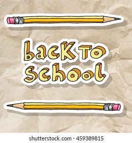 Hand drawn doodle Back to School words and two pencils over brown crumpled paper.