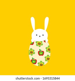 Hand drawn doodle cute kawaii white Easter bunny with funny face expression sitting on egg with floral pattern on yellow background. Holiday greeting card kids room nursery wall art