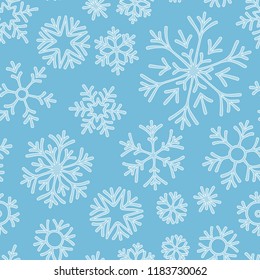 Hand drawn doodle seamless pattern. Blue snowflakes on a dark background. For fabric, textile, wrapping paper, card, invitation, wallpaper, web design.
