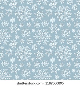 Hand drawn doodle seamless pattern. White snowflakes on a dark background. For fabric, textile, wrapping paper, card, invitation, wallpaper, web design.