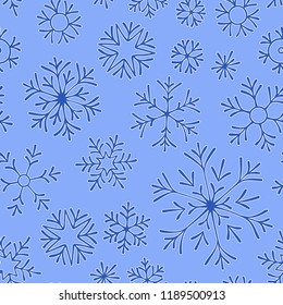 Hand drawn doodle seamless pattern. Blue snowflakes on a dark background. For fabric, textile, wrapping paper, card, invitation, wallpaper, web design.