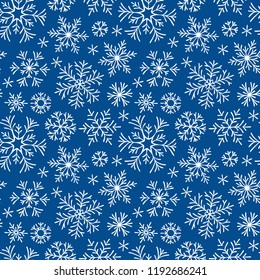 Hand drawn doodle seamless pattern. White snowflakes on a dark background. For fabric, textile, wrapping paper, card, invitation, wallpaper, web design.