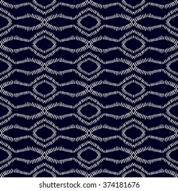 Hand drawn doodle seamless vector pattern. Ethnic textile collection. Sea motifs. White on dark blue.