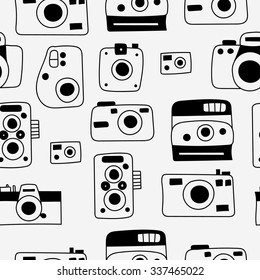 Hand drawn doodle style photo camera seamless pattern. Cute vector camera for poster, postcard, textile, wrapping paper design. Hand drawn style backgrounds.