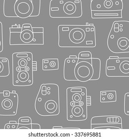 Hand drawn doodle style photo camera seamless pattern. Cute vector camera for poster, postcard, textile, wrapping paper design. Hand drawn style backgrounds.