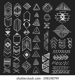 Hand drawn doodle vector tribal elements set (vol. 8 of 9). Decorative native american aztec symbols and geometric signs - triangle, arrows. White silhouettes isolated on black. 