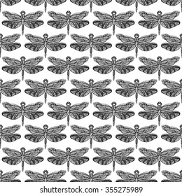 Hand drawn dragonfly ink doodle seamless pattern. Sketched insects on white background. Black and white monochrome fly flora print.