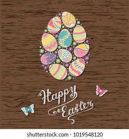 Hand drawn easter eggs composition on wooden background for greeting card design, Happy Ester lettering.